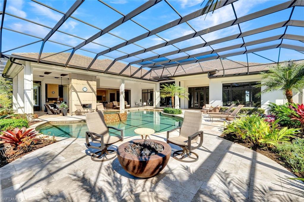 4431 Wayside Drive Naples, FL 34119 - Photo 28 of 49 a view of a patio with table and chairs potted plants with swimming pool