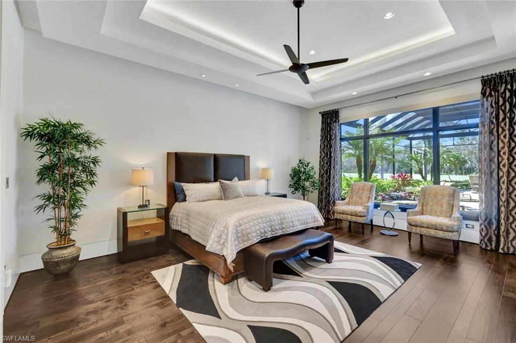 4431 Wayside Drive Naples, FL 34119 - Photo 30 of 49 a bedroom with a large bed and a potted plant