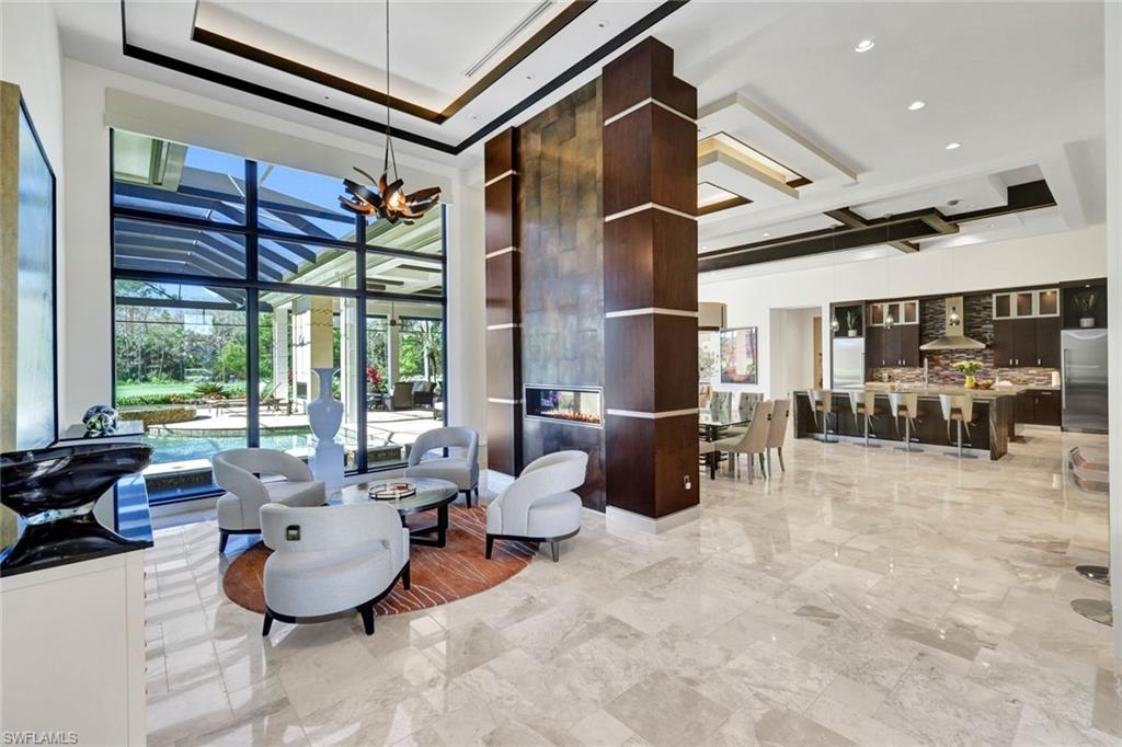4431 Wayside Drive Naples, FL 34119 - Photo 3 of 49 a living room with furniture a flat screen tv and a large window