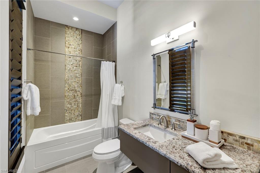 4431 Wayside Drive Naples, FL 34119 - Photo 39 of 49 a bathroom with a granite countertop sink toilet and shower