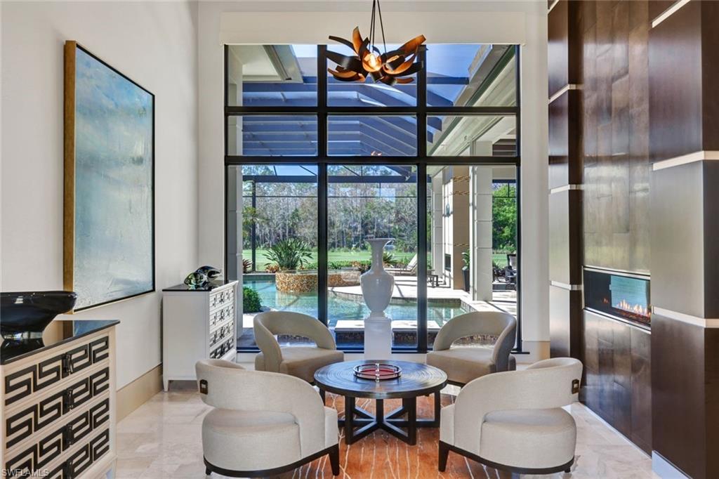 4431 Wayside Drive Naples, FL 34119 - Photo 4 of 49 a living room with furniture and a floor to ceiling window
