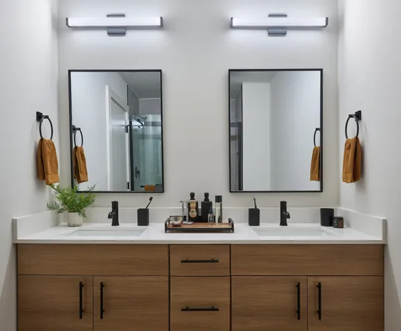 a bathroom with double vanity sinks and a mirror