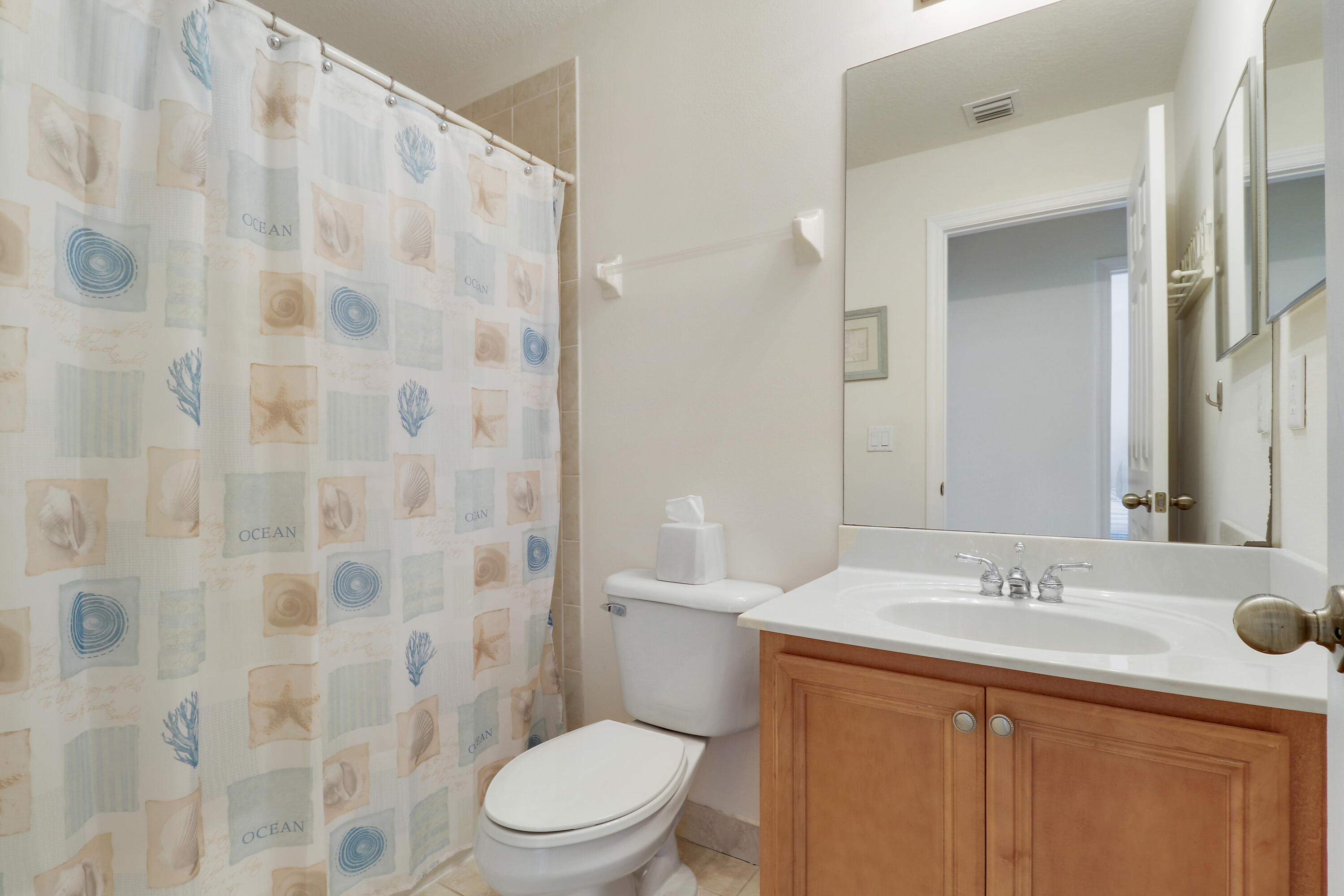 5410 Southeast Mitchell Lane Stuart, FL 34997 - Photo 20 of 24 a bathroom with a granite countertop sink a toilet and shower