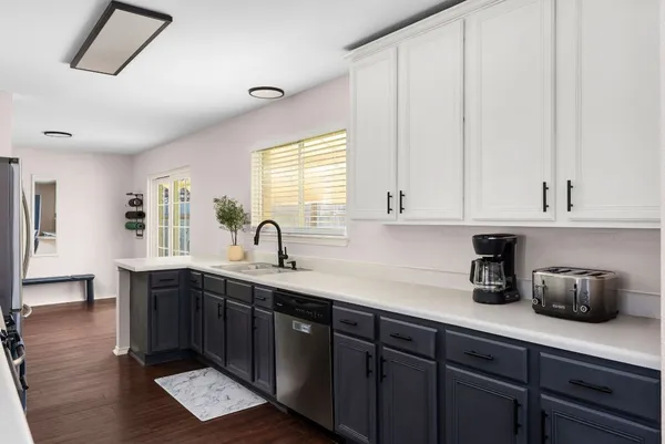 a kitchen with stainless steel appliances granite countertop a sink stove and microwave