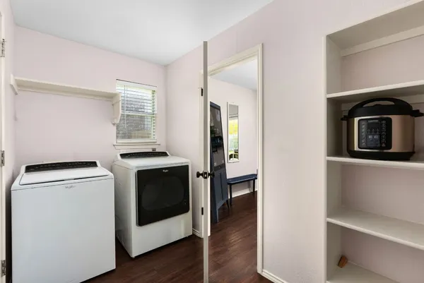 a bedroom with furniture and a large window