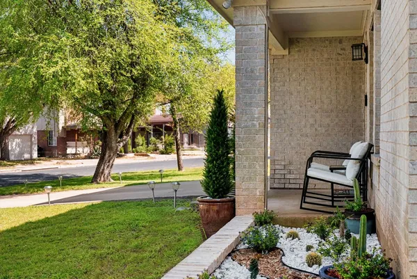a view of table with potted plant and wooden floor