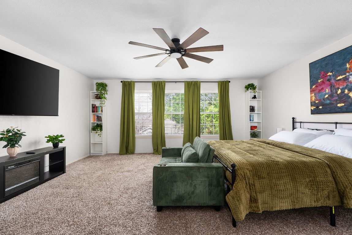 7906 Briarton Drive Austin, TX 78747 - Photo 21 of 38 a bedroom with a bed and a flat screen television
