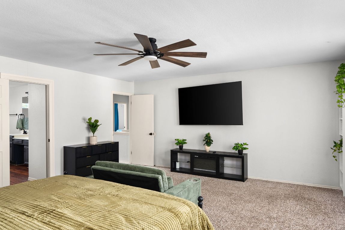 7906 Briarton Drive Austin, TX 78747 - Photo 22 of 38 a bedroom with a bed and a flat screen tv