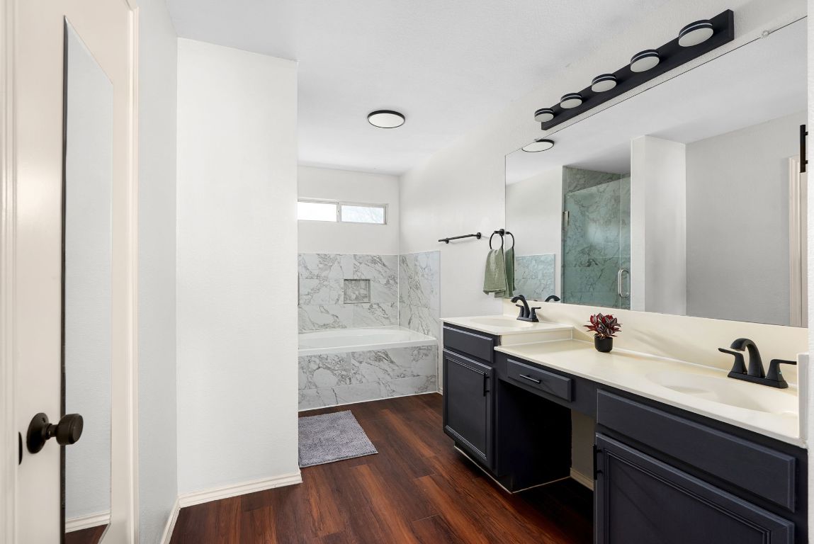 7906 Briarton Drive Austin, TX 78747 - Photo 24 of 38 a bathroom with a double vanity sink and mirror with shower