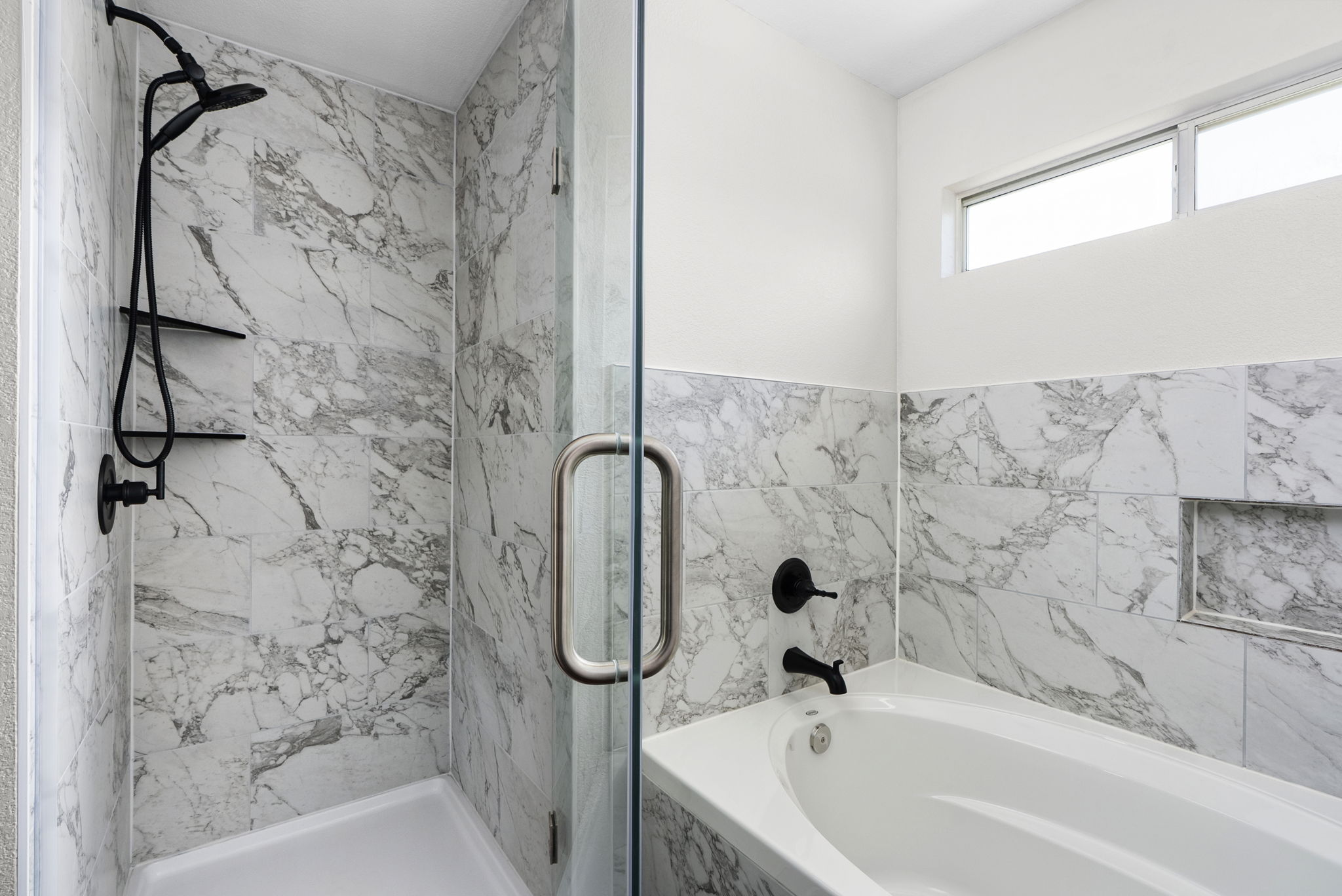 7906 Briarton Drive Austin, TX 78747 - Photo 25 of 38 a bathroom with a shower and a bathtub