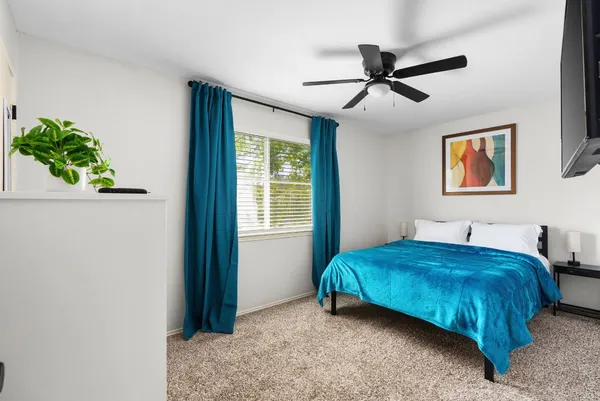 a bedroom with a bed and flat screen tv