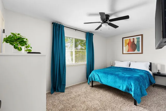 a bedroom with a bed and flat screen tv