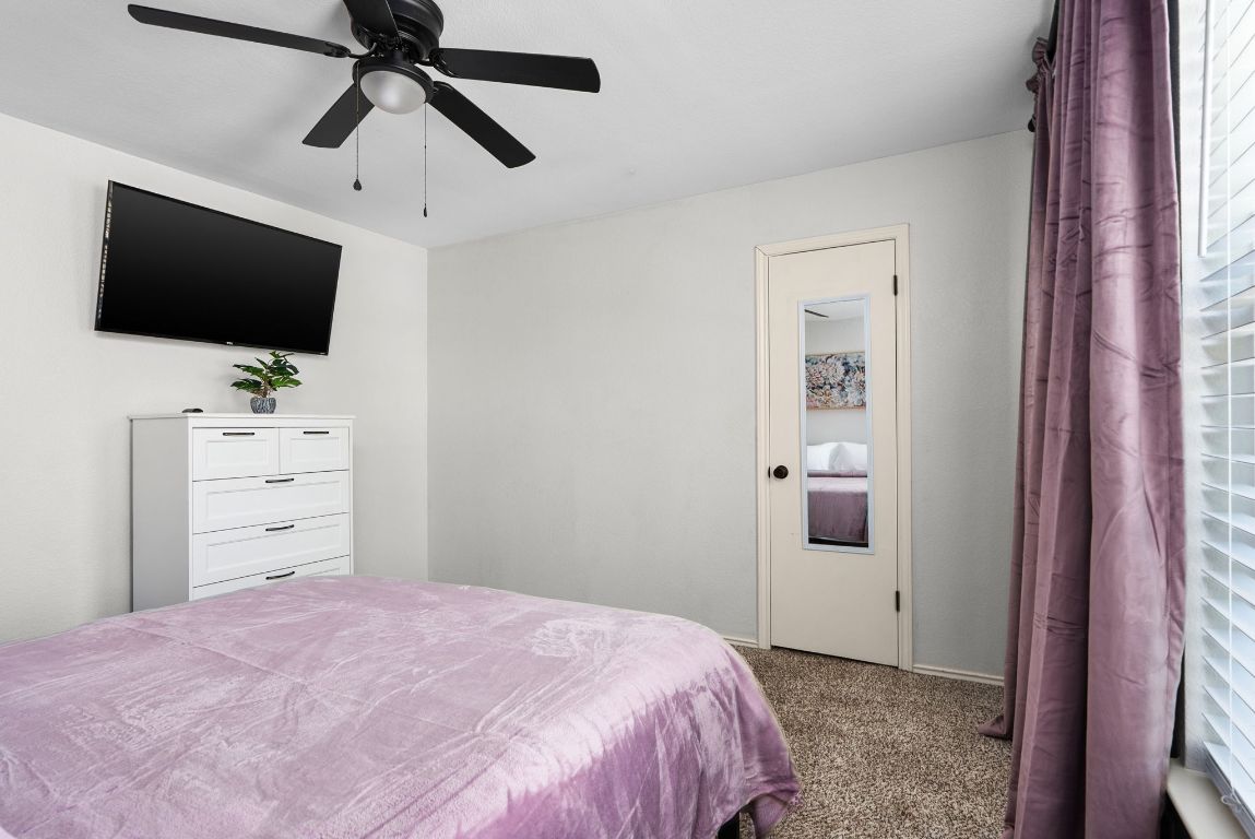 7906 Briarton Drive Austin, TX 78747 - Photo 29 of 38 a bedroom with a bed and flat screen tv