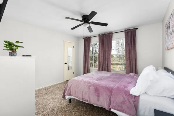 a bedroom with a bed and a desk