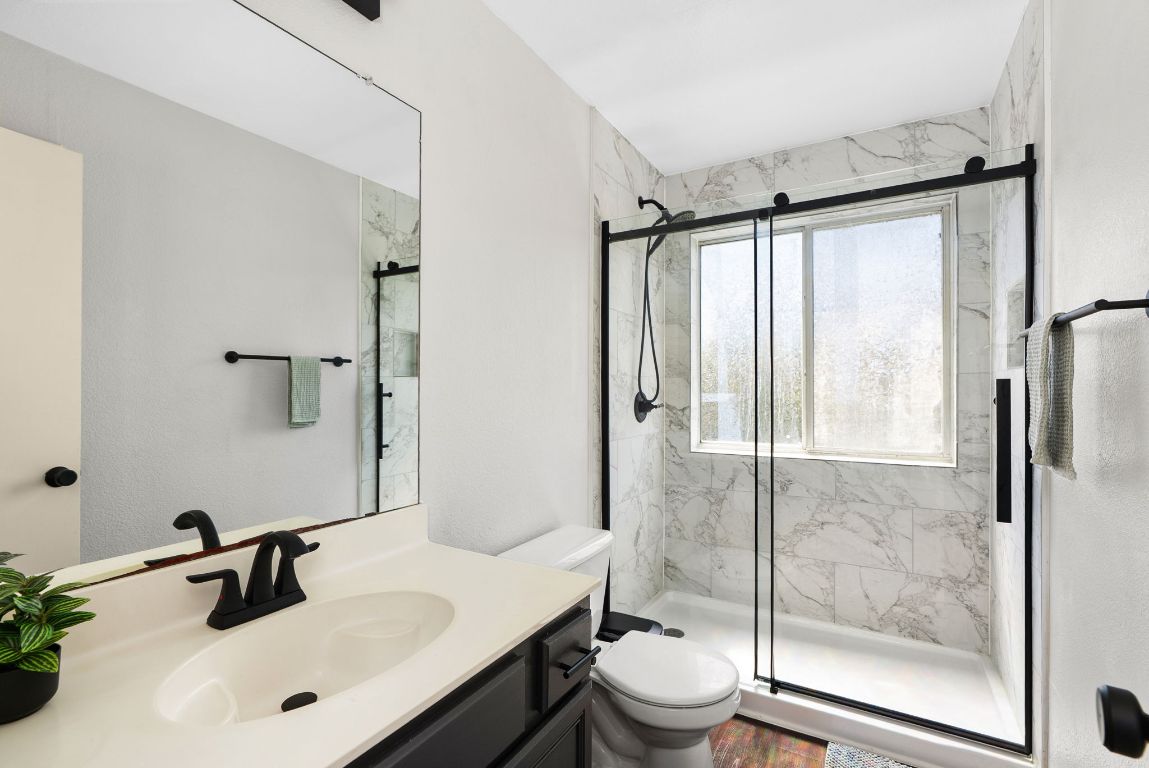 7906 Briarton Drive Austin, TX 78747 - Photo 34 of 38 a bathroom with a sink toilet and shower