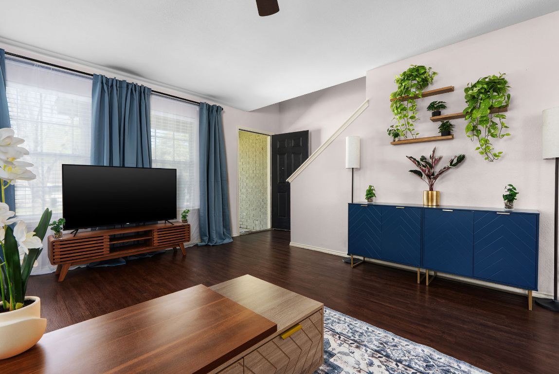 7906 Briarton Drive Austin, TX 78747 - Photo 4 of 38 a living room with furniture bookshelf and wooden floor