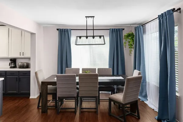 a dining room with furniture and window