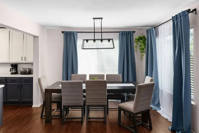 a dining room with furniture and window