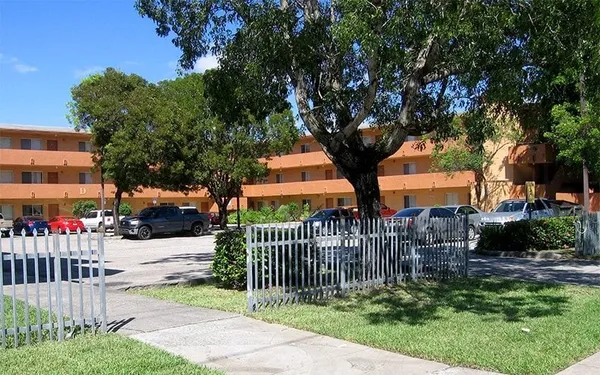 a view of a house with a small yard and plants