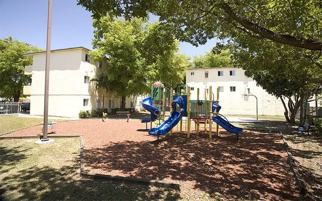 a view of a park with swings and slides