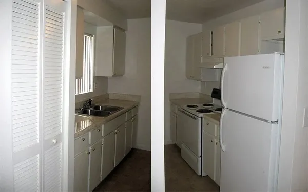 a kitchen with a stove a refrigerator and a sink