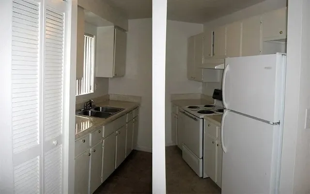 a kitchen with a stove a refrigerator and a sink