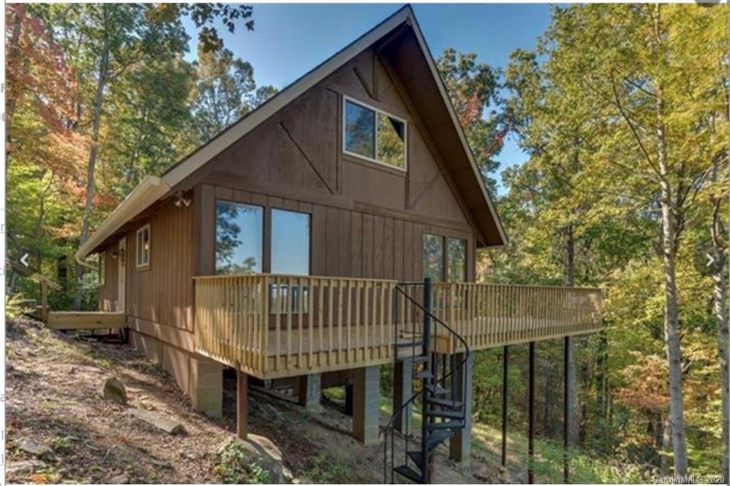 1550 Melrose Mountain Road Tryon, NC 28782 - Photo 1 of 1 a view of backyard with deck and outdoor seating