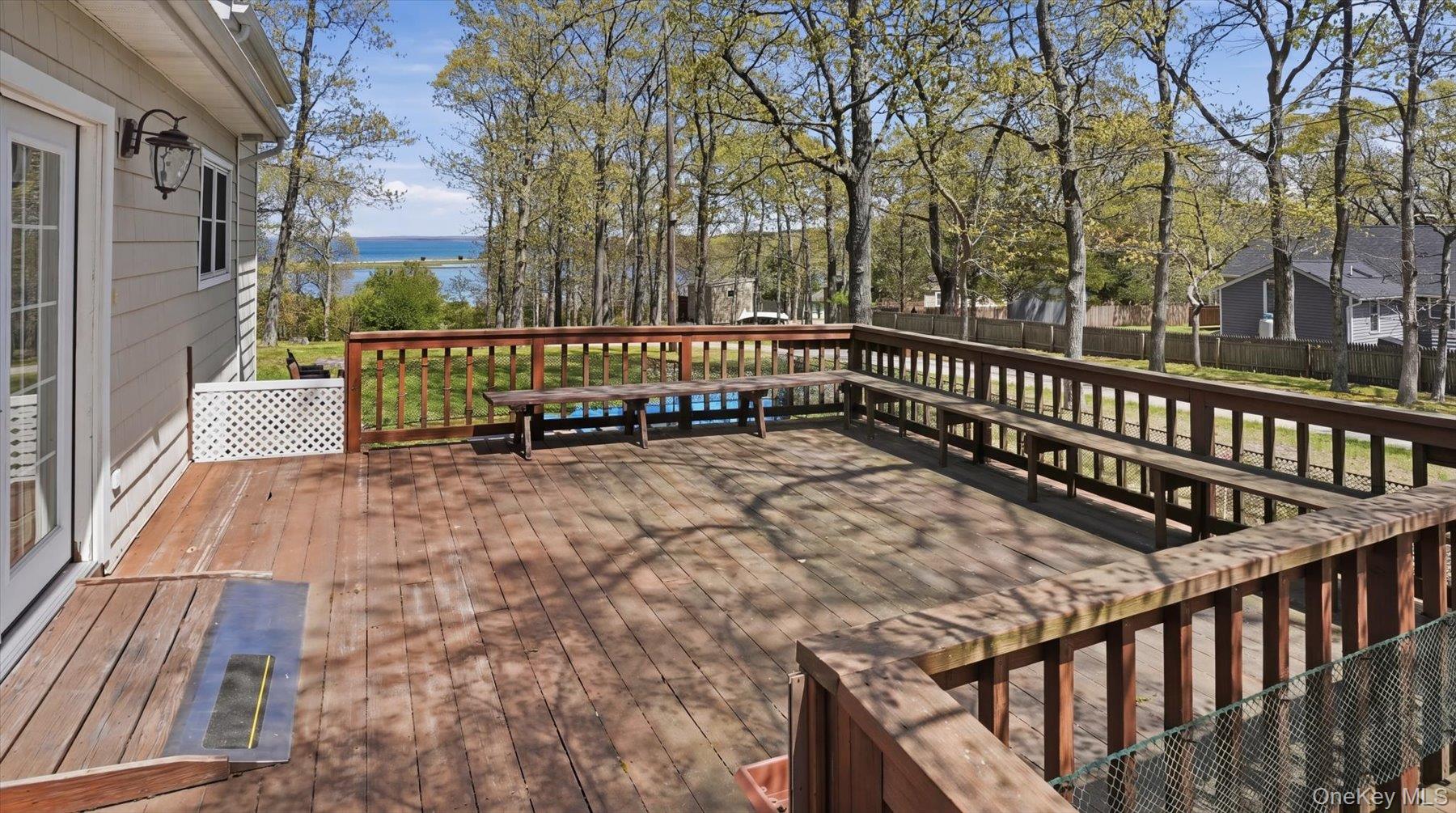32 Red Creek Road Hampton Bays, NY 11946 - Photo 3 of 18 a balcony with trees in front of it