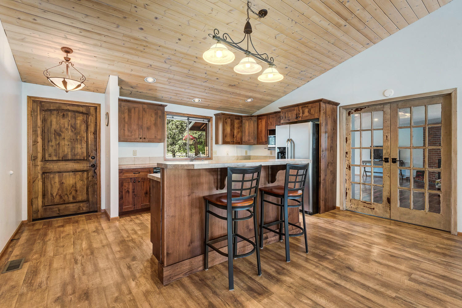 64736 Sylvan Loop Bend, OR 97701 - Photo 9 of 46 a kitchen with stainless steel appliances kitchen island granite countertop a refrigerator and microwave