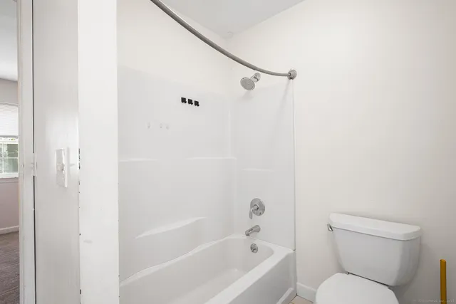 a bathroom with a toilet and a bathtub
