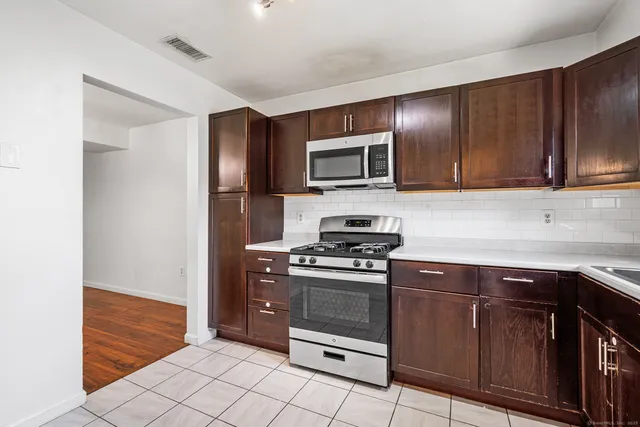 a kitchen with sink cabinets and stainless steel appliances