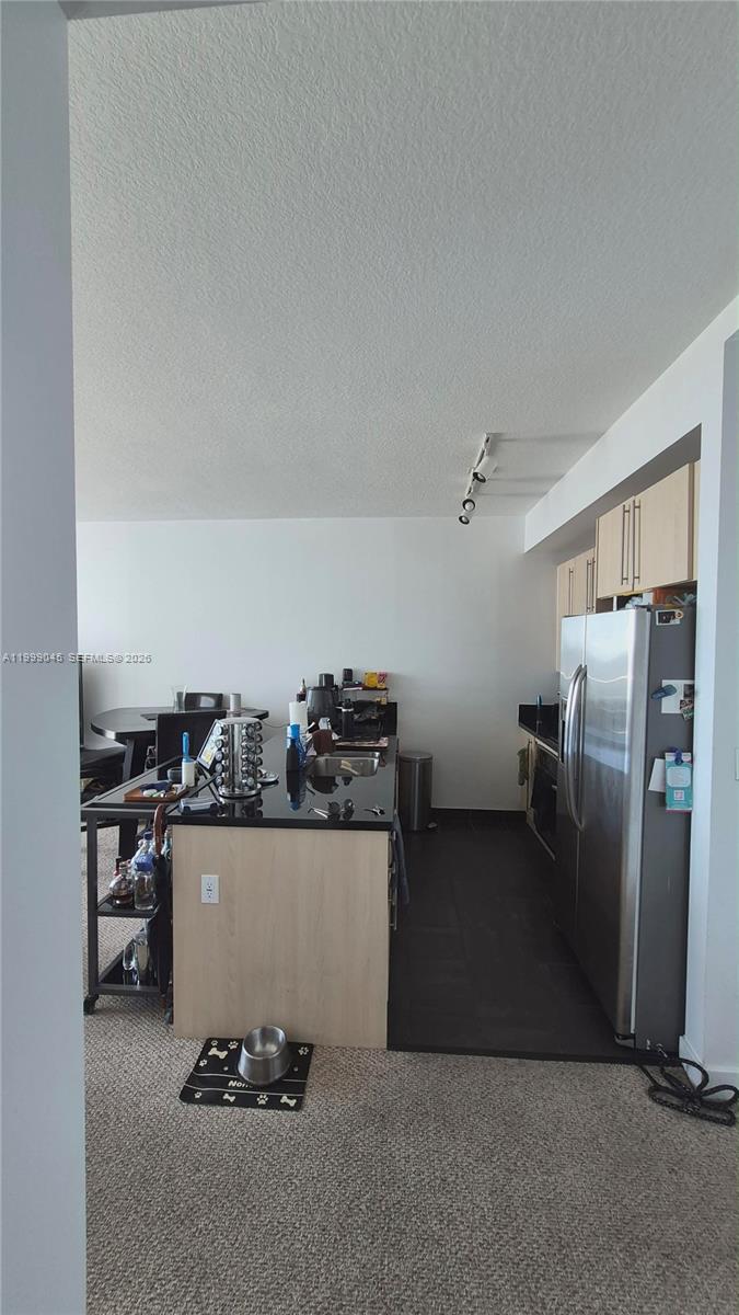 79 Southwest 12th Street, Unit 2702S Miami, FL 33130 - Photo 6 of 9 a view of a kitchen with refrigerator and stove