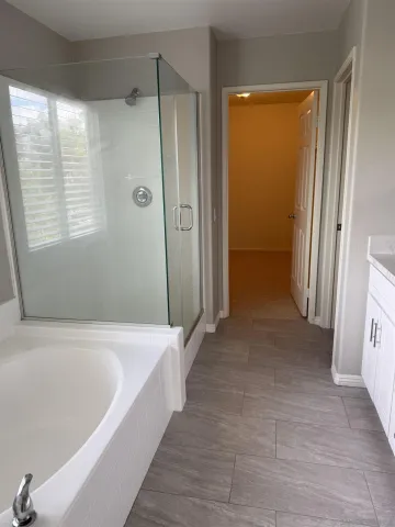 a bath tub sitting next to a window