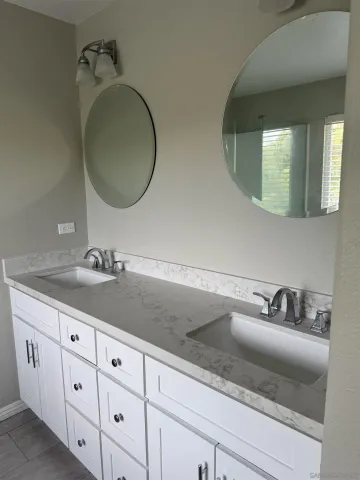 a white toilet sitting next to a wooden cabinet