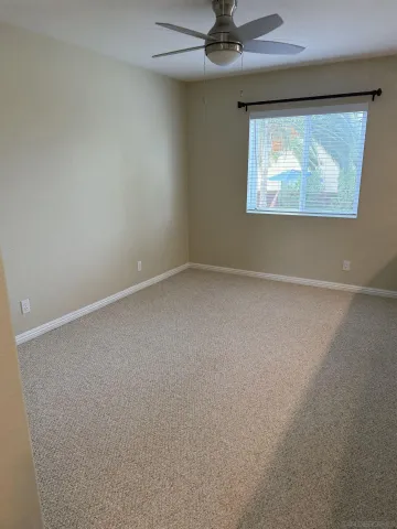 a bathroom with a toilet and a window