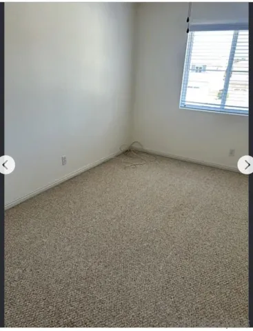 a bathroom with a double vanity sink and mirror with toilet