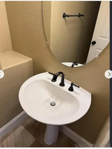 a bathroom with a sink and mirror