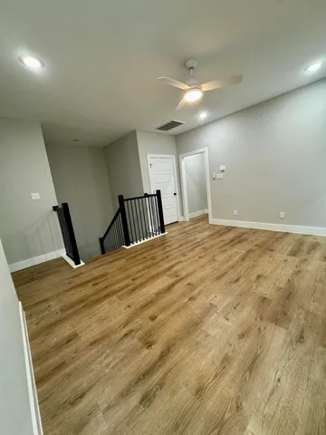 a view of a room with wooden floor