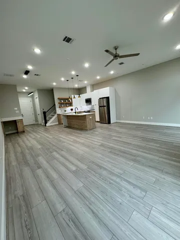 a view of a kitchen with a sink and a large window