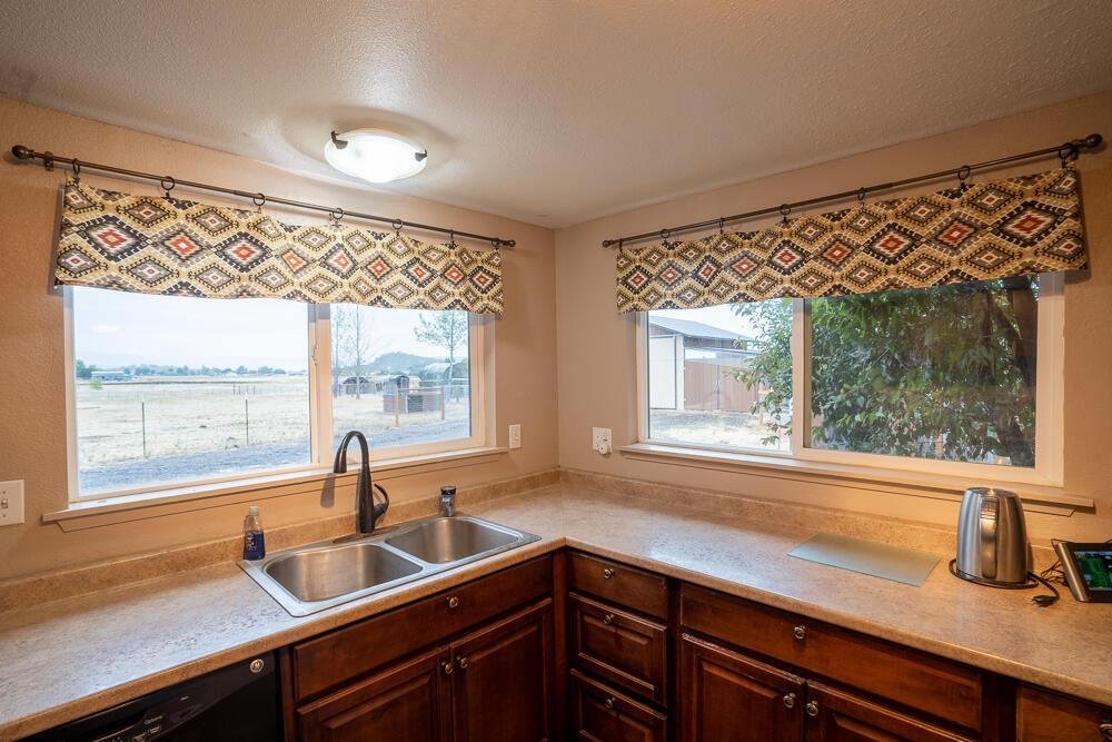 4579 Winnetka Road White City, OR 97503 - Photo 3 of 28 a kitchen with granite countertop a sink and a window