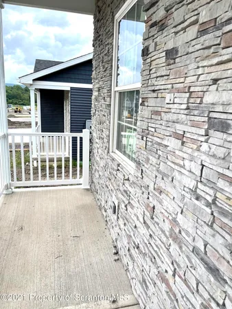 a view of front door of house with wooden floor