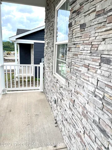 a view of front door of house with wooden floor