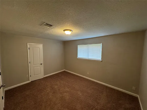 an empty room with a empty space and windows