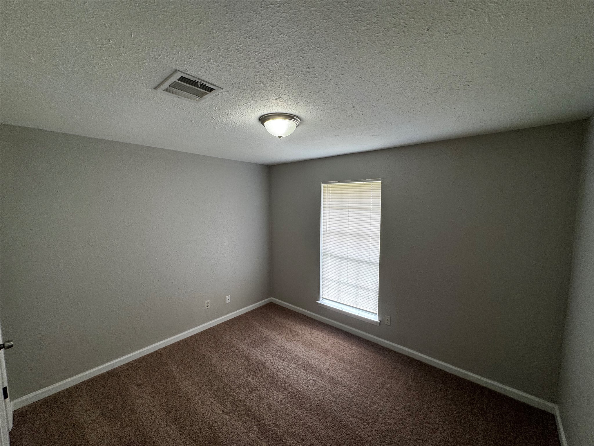 1922 Bunzel Street Houston, TX 77088 - Photo 10 of 16 an empty room with windows
