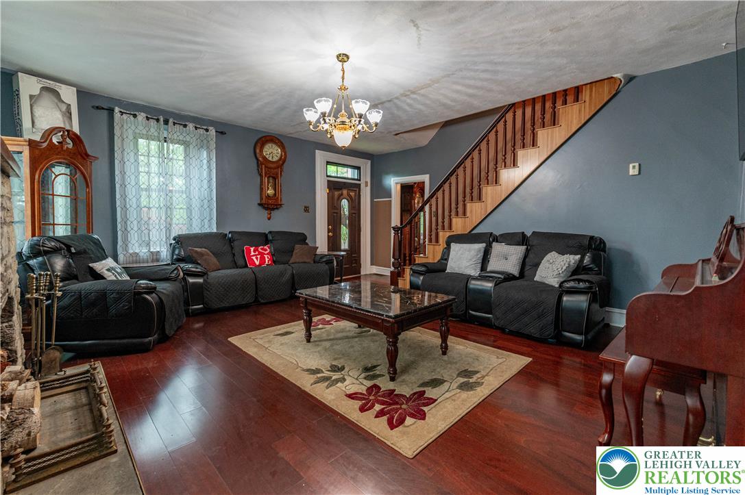 2485 Hieter Road Quakertown, PA 18951 - Photo 19 of 97 Rich hardwood floors create a warm ambiance throughout this inviting living space, complementing the elegant staircase.
