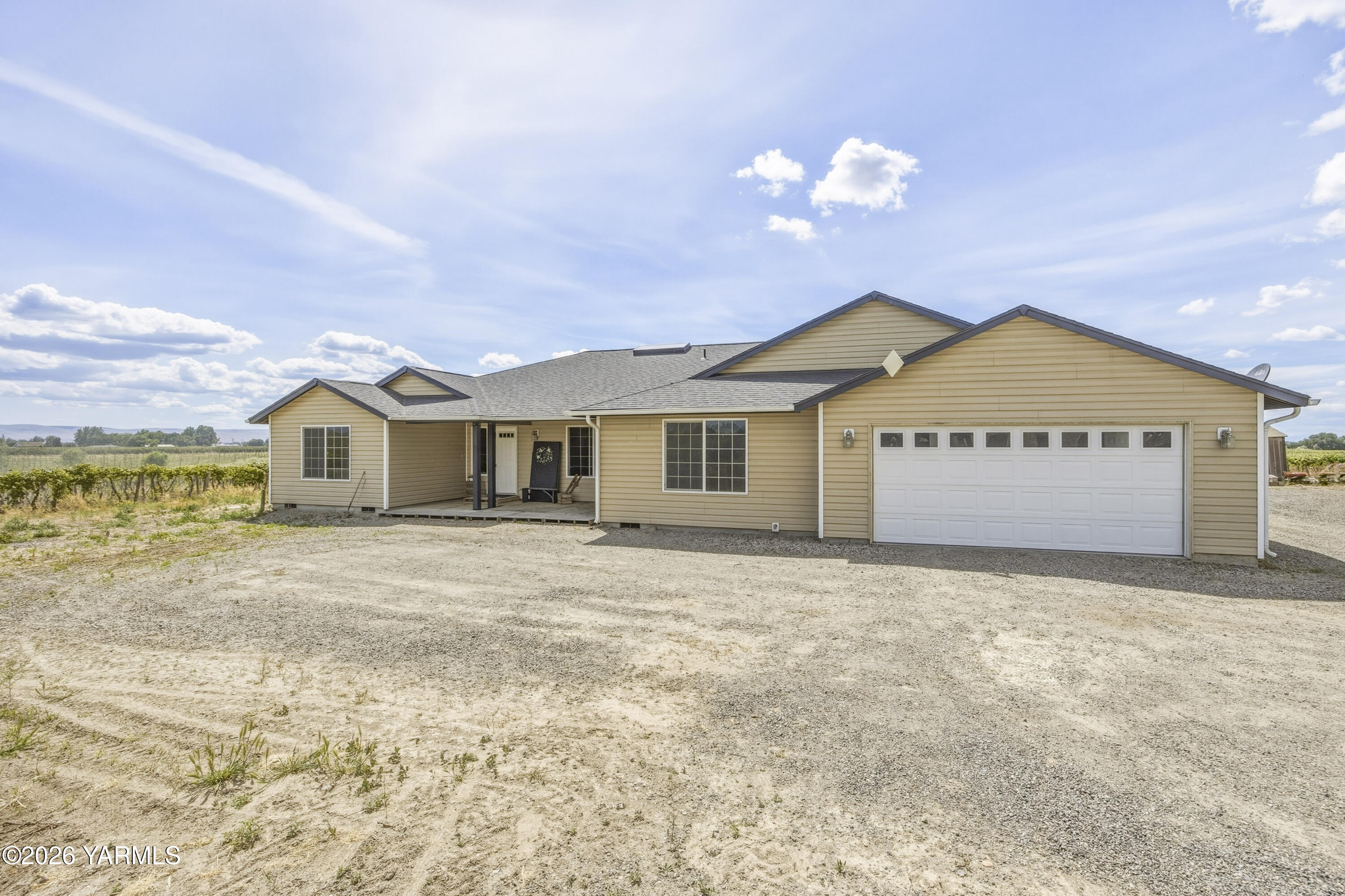2050 Olmstead Road Grandview, WA 98930 - Photo 18 of 60 a view of a house with a yard and garage