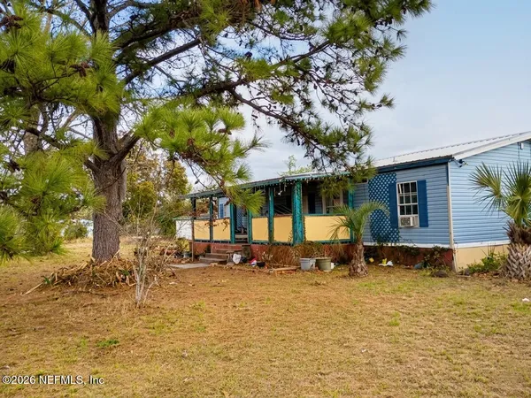 a front view of a house with a yard table and chairs