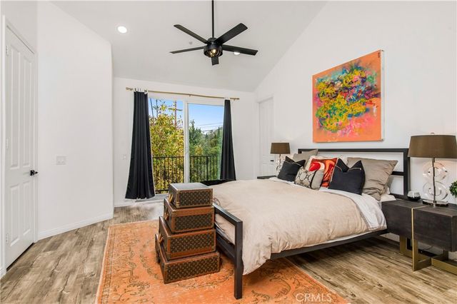 a bedroom with a bed and a painting on the wall