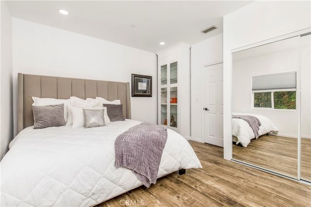 a spacious bedroom with a bed and a couch