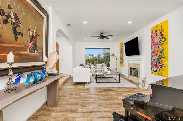 a living room with fireplace furniture and a flat screen tv